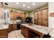 Well-lit kitchen with wood cabinetry, stainless steel appliances, and a granite-topped island at 16817 W Bradford Way, Surprise, AZ 85374