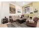 Comfortable living room featuring neutral tones, a cozy fireplace, and stylish decor at 16817 W Bradford Way, Surprise, AZ 85374