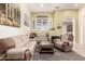 Cozy living area with neutral tones, a fireplace, and an abundance of natural light at 16817 W Bradford Way, Surprise, AZ 85374
