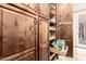Large wood pantry featuring an open drawer stocked with snacks, offering convenient storage at 16817 W Bradford Way, Surprise, AZ 85374