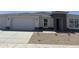 Beautiful single-story home featuring stone accents, a two-car garage, and low-maintenance desert landscaping at 17747 W Brown St, Waddell, AZ 85355