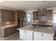Modern kitchen features updated stainless appliances, light countertops, custom cabinets, and a center island at 17747 W Brown St, Waddell, AZ 85355