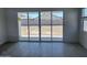 Living room with tile floors leading to large sliding glass doors and backyard views at 17747 W Brown St, Waddell, AZ 85355