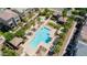 Aerial view of community pool and landscaping featuring palm trees at 1814 E Bridgeport Pkwy # 103, Gilbert, AZ 85295