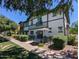 Beautiful condo exterior with back patio and seating area, shaded by mature trees, perfect for relaxing at 1814 E Bridgeport Pkwy # 103, Gilbert, AZ 85295