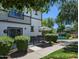 Charming back patio with an umbrella and outdoor seating, overlooking the community pond and lush landscaping at 1814 E Bridgeport Pkwy # 103, Gilbert, AZ 85295