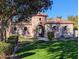 A charming clubhouse welcomes residents with its stone tower and lush landscaping at 1814 E Bridgeport Pkwy # 103, Gilbert, AZ 85295