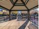 Serene community gazebo on a wooden deck overlooking a lake and community at 1814 E Bridgeport Pkwy # 103, Gilbert, AZ 85295