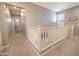 Upstairs hallway featuring plush carpeting, providing a comfortable transition between rooms at 1814 E Bridgeport Pkwy # 103, Gilbert, AZ 85295