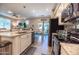 Modern kitchen featuring granite countertops, stainless steel appliances, and a breakfast bar, ideal for entertaining at 1814 E Bridgeport Pkwy # 103, Gilbert, AZ 85295