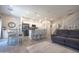 Open concept living room and dining area with tile floors, a modern kitchen, and a staircase at 1814 E Bridgeport Pkwy # 103, Gilbert, AZ 85295
