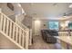 Open-concept living room featuring a staircase and neutral tones, great for gatherings at 1814 E Bridgeport Pkwy # 103, Gilbert, AZ 85295