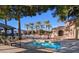 A tranquil hot tub with a community pool, with lush greenery and shady trees around the pool at 1814 E Bridgeport Pkwy # 103, Gilbert, AZ 85295