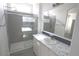 Bright bathroom with marble countertops, grey tile, and glass enclosed shower at 1820 N Thornton Rd # 917, Casa Grande, AZ 85122