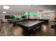 Game room features multiple billiard tables with pendant lighting overhead and hardwood floors at 1820 N Thornton Rd # 917, Casa Grande, AZ 85122