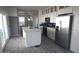 Modern kitchen with stainless steel appliances, white cabinets, and a large island for meal preparation at 1820 N Thornton Rd # 917, Casa Grande, AZ 85122