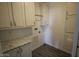 Functional laundry room with storage cabinets and countertop space for efficient laundry tasks at 1820 N Thornton Rd # 917, Casa Grande, AZ 85122