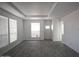 Inviting living room featuring a tray ceiling and large windows that fill the space with light at 1820 N Thornton Rd # 917, Casa Grande, AZ 85122