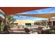 Relaxing pool area with palm trees, seating, shade, and blue skies at 1820 N Thornton Rd # 917, Casa Grande, AZ 85122