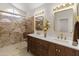 Bathroom showcasing double sinks, elegant granite counters, and beautifully tiled shower at 19443 N 36Th St, Phoenix, AZ 85050
