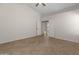 Spacious bedroom featuring tile flooring and double doors leading to the ensuite bathroom at 19443 N 36Th St, Phoenix, AZ 85050