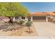 Charming single-story home with a tile roof, two-car garage, and desert landscaping for low maintenance appeal at 19443 N 36Th St, Phoenix, AZ 85050