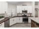 White kitchen with updated stainless-steel appliances and wood countertops at 19443 N 36Th St, Phoenix, AZ 85050