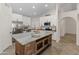Bright kitchen with stainless steel appliances, a large island, and ample cabinet space at 19443 N 36Th St, Phoenix, AZ 85050