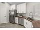 Bright kitchen with stainless appliances, white cabinets, and butcher block countertops at 19443 N 36Th St, Phoenix, AZ 85050