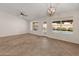 Bright living room featuring tile flooring, backyard access, and modern lighting at 19443 N 36Th St, Phoenix, AZ 85050