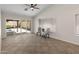 Bright living room with ceiling fan and sliding doors leading to pool at 19443 N 36Th St, Phoenix, AZ 85050
