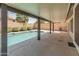 Inviting outdoor patio with a clear view of the pool and waterfall feature, surrounded by manicured landscaping at 19443 N 36Th St, Phoenix, AZ 85050