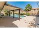Beautiful pool area with clear water, lush landscaping and covered patio providing shade for relaxation at 19443 N 36Th St, Phoenix, AZ 85050