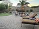 Spacious backyard with a fire pit, outdoor furniture, putting green, and desert plants at 2 W Pasture Canyon Dr, San Tan Valley, AZ 85143