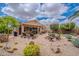 Expansive backyard featuring a covered patio, outdoor kitchen, fire pit, and desert landscape at 2 W Pasture Canyon Dr, San Tan Valley, AZ 85143
