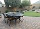 Charming backyard with an outdoor dining set, putting green, and neatly designed landscaping at 2 W Pasture Canyon Dr, San Tan Valley, AZ 85143