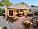 Inviting backyard patio with a fire pit, lounge chairs, outdoor seating, and stylish decor for relaxing evenings at 2 W Pasture Canyon Dr, San Tan Valley, AZ 85143