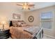 Comfortable bedroom includes a ceiling fan, tiled floors, and neutral decor for a relaxing space at 2 W Pasture Canyon Dr, San Tan Valley, AZ 85143