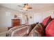 Bedroom with a wooden bed, a window, and a wooden dresser with a hat and other decor at 2 W Pasture Canyon Dr, San Tan Valley, AZ 85143
