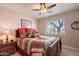 Bedroom with a wooden bed, a window, a ceiling fan, and a wooden bedside table and lamp at 2 W Pasture Canyon Dr, San Tan Valley, AZ 85143