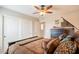 Bedroom features a comfortable bed, ceiling fan, closet, and rustic accents for a warm atmosphere at 2 W Pasture Canyon Dr, San Tan Valley, AZ 85143