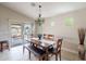 Dining room with wooden table and bench, chandelier, and sliding door to the backyard at 2 W Pasture Canyon Dr, San Tan Valley, AZ 85143