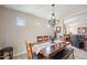 Bright dining room features wood table, matching chairs, a bench and decorative chandelier at 2 W Pasture Canyon Dr, San Tan Valley, AZ 85143