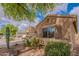 Well-maintained home exterior with desert landscaping, a window with shutters, and a peaceful residential street at 2 W Pasture Canyon Dr, San Tan Valley, AZ 85143