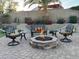 Charming outdoor fire pit with seating, complemented by lush landscaping and a cozy ambiance at 2 W Pasture Canyon Dr, San Tan Valley, AZ 85143