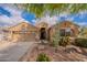 Charming home exterior with a well-manicured desert landscape, a two-car garage, and a welcoming entrance at 2 W Pasture Canyon Dr, San Tan Valley, AZ 85143