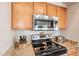 Close-up on kitchen with stainless appliances, granite counters and wood cabinets at 2 W Pasture Canyon Dr, San Tan Valley, AZ 85143