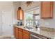 Well-lit kitchen with granite countertops, stainless steel appliances, and modern fixtures at 2 W Pasture Canyon Dr, San Tan Valley, AZ 85143