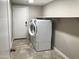 Laundry room with a white washer and dryer, a white door, and a shelf at 2 W Pasture Canyon Dr, San Tan Valley, AZ 85143