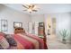 Spacious main bedroom with ensuite bathroom access, archway, ceiling fan, tiled floors, and warm decor at 2 W Pasture Canyon Dr, San Tan Valley, AZ 85143